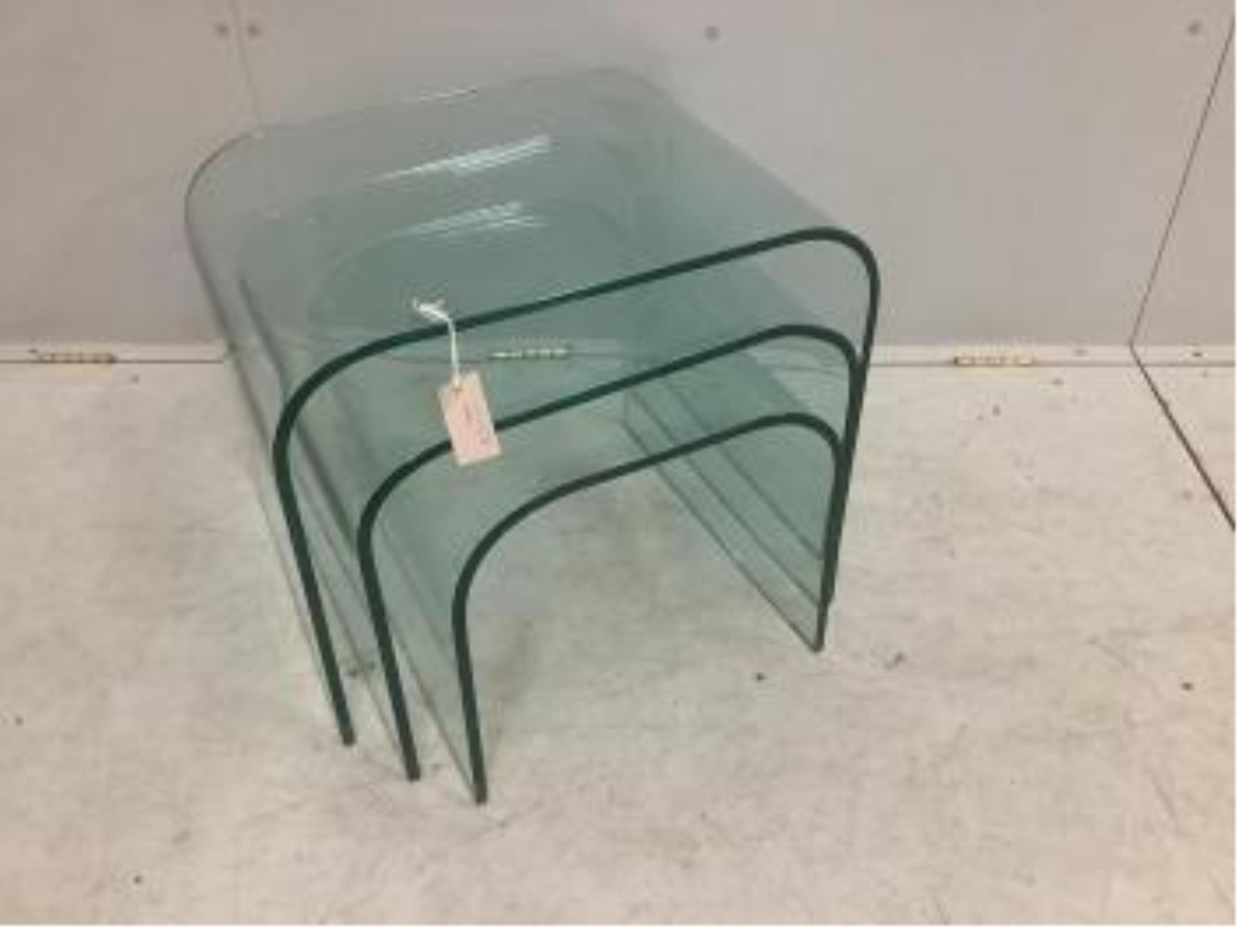 A nest of three Contemporary curved glass tables, width 59cm, depth 44cm, height 45cm. Condition - good